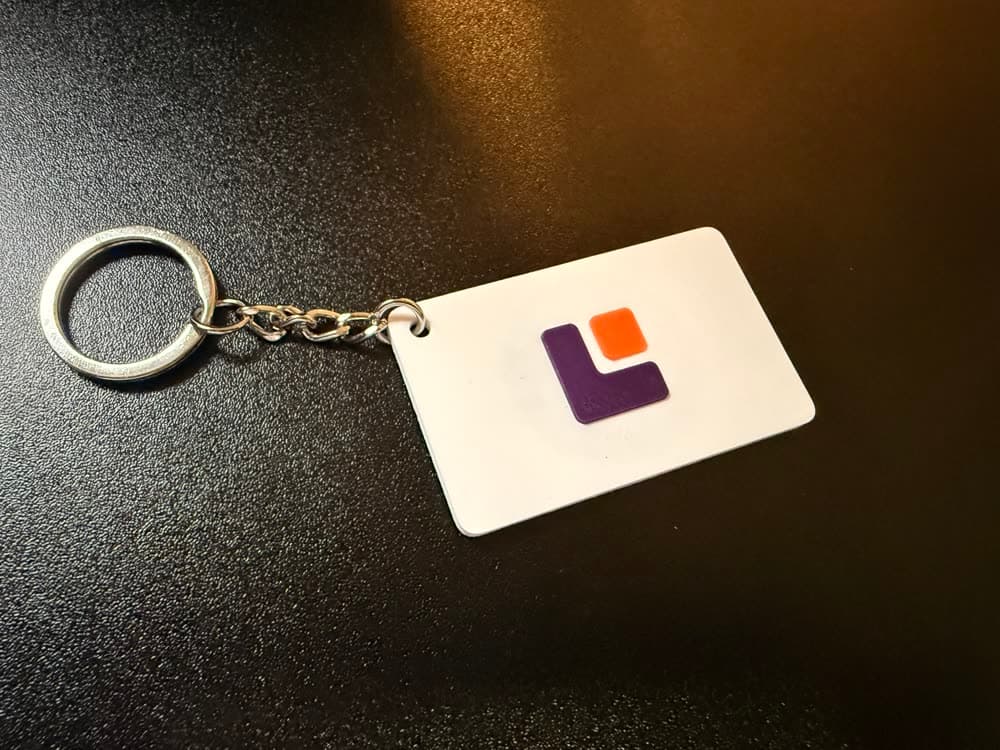 A white keychain with the LeadTap.me logo