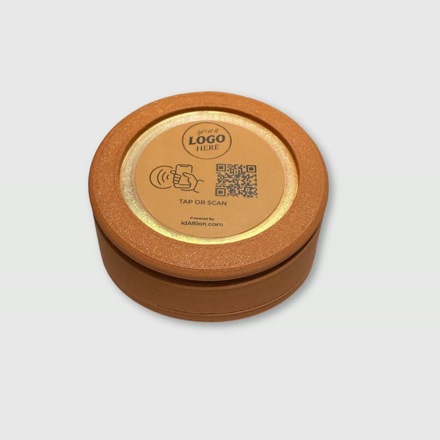 A round touchpoint with a glowing ring, logo and QR code